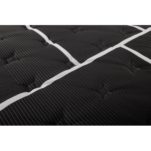 Restonic Black Hybrid Plush mattress close-up: black quilted fabric with white piping.