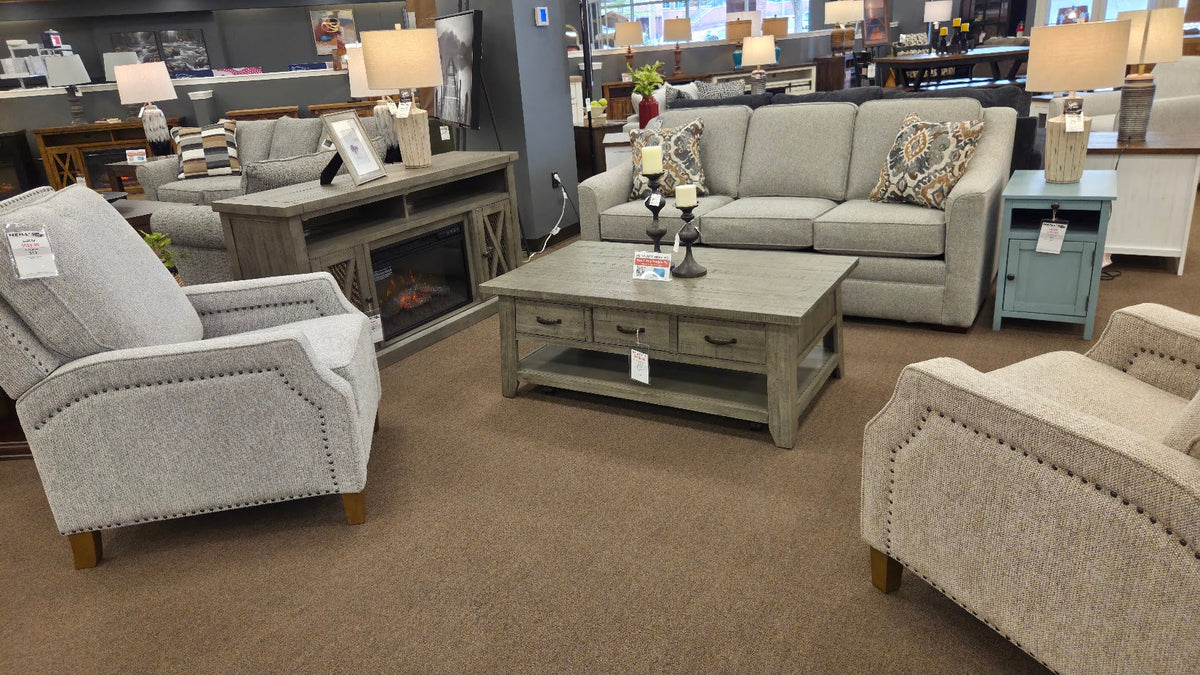Sofa, armchairs, coffee table, and lamps displayed at Neill’s Home Store in Branson