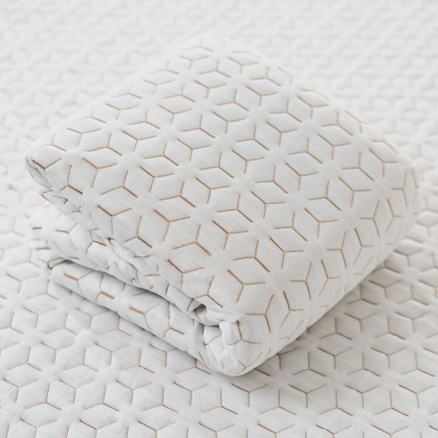 Copper Mattress Protector folded showing geometric copper-infused fabric