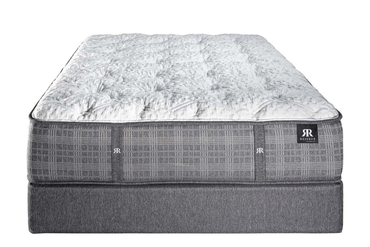 Reserve Royal Cushion Firm mattress with quilted white top and gray base featuring a moisture-wicking Tencel cover.